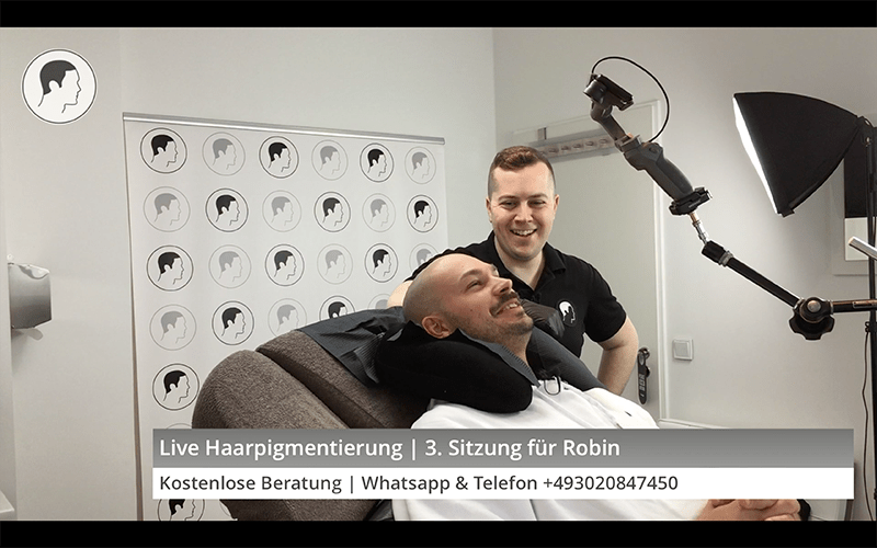 Robin and George enjoying themselves during a live scalp micropigmentation session