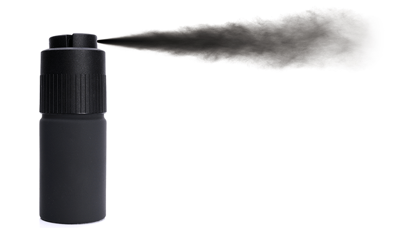 Tinted root spray from a can being used to mask hair loss